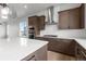 Stylish kitchen showcasing custom cabinets, stainless appliances, a hood, and stone countertops at 14283 Currant St, Broomfield, CO 80020