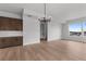 Well-lit, open-concept living space, showcasing modern chandelier and a seamless flow to the kitchen at 14283 Currant St, Broomfield, CO 80020