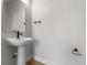 Powder room with pedestal sink and modern black fixtures at 14283 Currant St, Broomfield, CO 80020