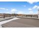 Expansive roof deck with mountain views, metal railing, and partial snow covering provides outdoor living space at 14283 Currant St, Broomfield, CO 80020