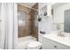 Clean bathroom with shower/tub combo and white vanity at 1818 S Quitman St, Denver, CO 80219