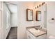 Simple bathroom with a vanity, mirror, and access to another room at 137 S Bedford Ave, Castle Rock, CO 80104