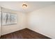 Bright bedroom with wood floors, window, and exterior door at 137 S Bedford Ave, Castle Rock, CO 80104