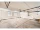 Attached garage with light-colored concrete floor and two windows at 137 S Bedford Ave, Castle Rock, CO 80104