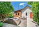 Backyard featuring outdoor seating, a fire pit, privacy fence, and well-maintained landscaping at 3425 W Moncrieff Pl, Denver, CO 80211