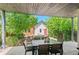 Outdoor patio with dining table, chairs, and a view of the lush backyard at 3425 W Moncrieff Pl, Denver, CO 80211