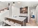Stylish bar with a quartz countertop, undermount sink, wine cooler and floating shelves at 3425 W Moncrieff Pl, Denver, CO 80211
