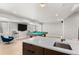 Basement with a pool table, tv and bar area with an undermount sink and modern fixtures at 3425 W Moncrieff Pl, Denver, CO 80211