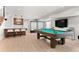 Finished basement featuring pool table, custom bar, modern seating, and media center at 3425 W Moncrieff Pl, Denver, CO 80211