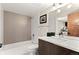 Bathroom featuring a tub with tiled surround, modern vanity, mirror and contemporary fixtures at 3425 W Moncrieff Pl, Denver, CO 80211