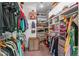 Walk in closet featuring ample built-in shelving for shoes, handbags and folded clothing at 3425 W Moncrieff Pl, Denver, CO 80211