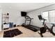 Workout room equipped with a treadmill, exercise bike, TV, and ample space for activities at 3425 W Moncrieff Pl, Denver, CO 80211