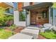 Close up of modern two-story home featuring a red front door and stained wood accents at 3425 W Moncrieff Pl, Denver, CO 80211