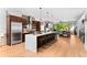 Spacious kitchen with stainless steel appliances, hardwood floors and a large center island with bar stool seating at 3425 W Moncrieff Pl, Denver, CO 80211