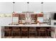 Stylish kitchen with a large island, seating, stainless steel appliances, and modern fixtures at 3425 W Moncrieff Pl, Denver, CO 80211