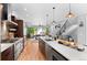 Modern kitchen with stainless steel appliances, island seating, and an open concept layout at 3425 W Moncrieff Pl, Denver, CO 80211