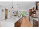 Beautiful modern kitchen featuring a large island with seating and stainless steel appliances at 3425 W Moncrieff Pl, Denver, CO 80211