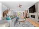 Spacious living room featuring a large sectional, hardwood floors, fireplace, open staircase and kitchen at 3425 W Moncrieff Pl, Denver, CO 80211