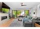 Open living room with large sectional couch, built-in shelving, fireplace, and sliding glass doors to outdoor space at 3425 W Moncrieff Pl, Denver, CO 80211