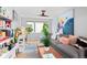 Bright living room featuring modern desk, stylish furniture, and decorative artwork at 3425 W Moncrieff Pl, Denver, CO 80211