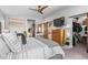Inviting main bedroom with warm decor, ceiling fan, and barn door bathroom access at 3425 W Moncrieff Pl, Denver, CO 80211