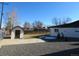 Spacious backyard with a shed, gravel area, and partial snow cover at 2262 Ammons St, Lakewood, CO 80214