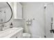 Modern bathroom with white vanity, updated fixtures, and a shower at 2262 Ammons St, Lakewood, CO 80214