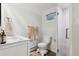 Well-lit bathroom features a modern vanity, toilet, and glass-enclosed shower at 2262 Ammons St, Lakewood, CO 80214