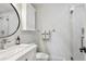 Bathroom featuring a white vanity, modern fixtures, a toilet, and a glass-enclosed shower for a sleek look at 2262 Ammons St, Lakewood, CO 80214