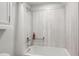 Bathroom with shower/tub combo and white cabinets at 2262 Ammons St, Lakewood, CO 80214