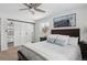 Bedroom featuring built-in mirror closets, plush bedding, and natural light from the window at 2262 Ammons St, Lakewood, CO 80214