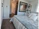 Bright bedroom with a laundry room entrance, a large painting on the wall, and two large windows at 2262 Ammons St, Lakewood, CO 80214