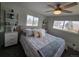 Bright bedroom with ceiling fan, soft bedding, natural light, and shelves next to the bedside tables at 2262 Ammons St, Lakewood, CO 80214