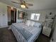 Light, bright bedroom with carpet flooring, ceiling fan, and adjacent laundry room, giving the room a relaxed feel at 2262 Ammons St, Lakewood, CO 80214