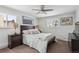Comfortable bedroom with large windows, side tables and lamps, carpeted floors, and a ceiling fan at 2262 Ammons St, Lakewood, CO 80214