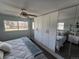 Bright bedroom featuring a ceiling fan, natural light, built in wardrobe with mirror doors, and carpet flooring at 2262 Ammons St, Lakewood, CO 80214