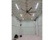 Spacious garage with spray foam insulation, overhead lighting, and a ceiling fan at 2262 Ammons St, Lakewood, CO 80214