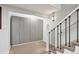 Hallway features a set of gray closets, staircase, carpet, and light fixture at 2262 Ammons St, Lakewood, CO 80214