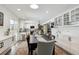 Bright kitchen with white cabinets, stainless steel appliances and dining area at 2262 Ammons St, Lakewood, CO 80214