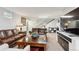 Basement living room features two leather sofas, a coffee table, a TV and a staircase at 2262 Ammons St, Lakewood, CO 80214