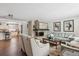 Spacious living room features a fireplace and kitchen view at 2262 Ammons St, Lakewood, CO 80214