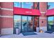 Close up of the entrance to the lofts on a brick building with large glass doors at 10111 Inverness Main St # 230, Englewood, CO 80112