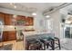Well-lit kitchen featuring modern stainless steel appliances, wooden cabinets, and a center island with a granite countertop at 10111 Inverness Main St # 230, Englewood, CO 80112