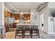 Stylish kitchen with a stainless steel refrigerator, wooden cabinets, and a center island with decorative front panels at 10111 Inverness Main St # 230, Englewood, CO 80112