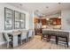 Bright kitchen with stainless steel appliances, wooden cabinets, a center island with bar seating, and hardwood floors at 10111 Inverness Main St # 230, Englewood, CO 80112