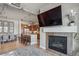Open floor plan showcasing the kitchen, dining, and living areas, complete with a fireplace and hardwood floors at 10111 Inverness Main St # 230, Englewood, CO 80112