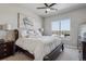 Serene bedroom with a large bed, bedside tables, and a bright window with city views and neutral paint at 10111 Inverness Main St # 230, Englewood, CO 80112