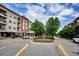 Street view of condos with mature trees and green spaces, showing the neighborhood at 10111 Inverness Main St # 230, Englewood, CO 80112