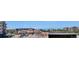 Panoramic view of the town center with diverse buildings, trees, parked cars, and mountains in the distance at 10111 Inverness Main St # 230, Englewood, CO 80112
