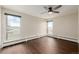 Bright bedroom with large windows and dark brown wood flooring at 310 S Ames St # 11, Lakewood, CO 80226